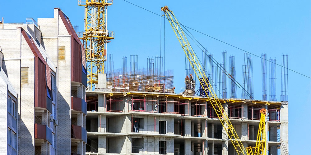 finished,apartment,building,and,a,new,high rise,building,construction,site